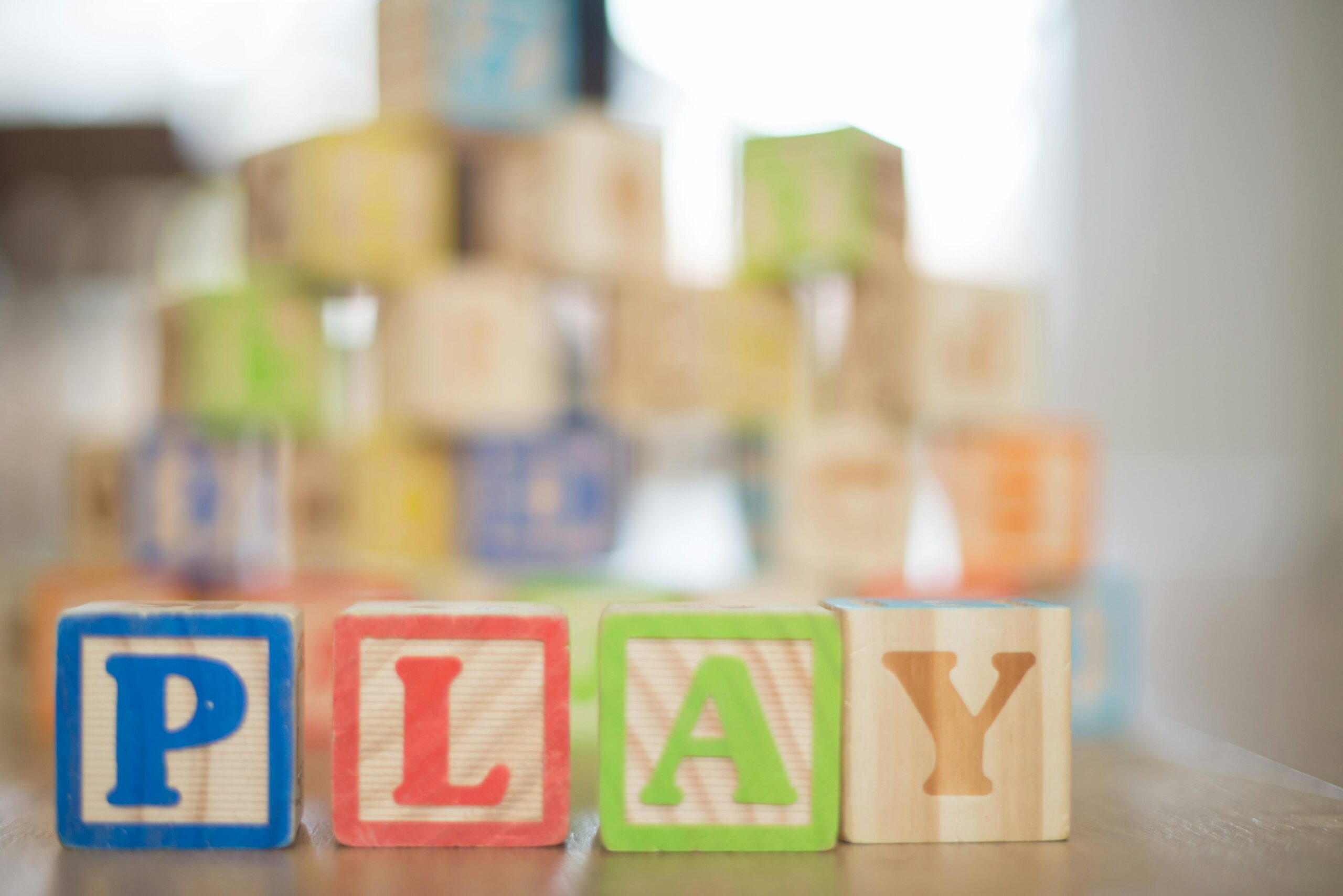 children's toy block spelling the word "Play"