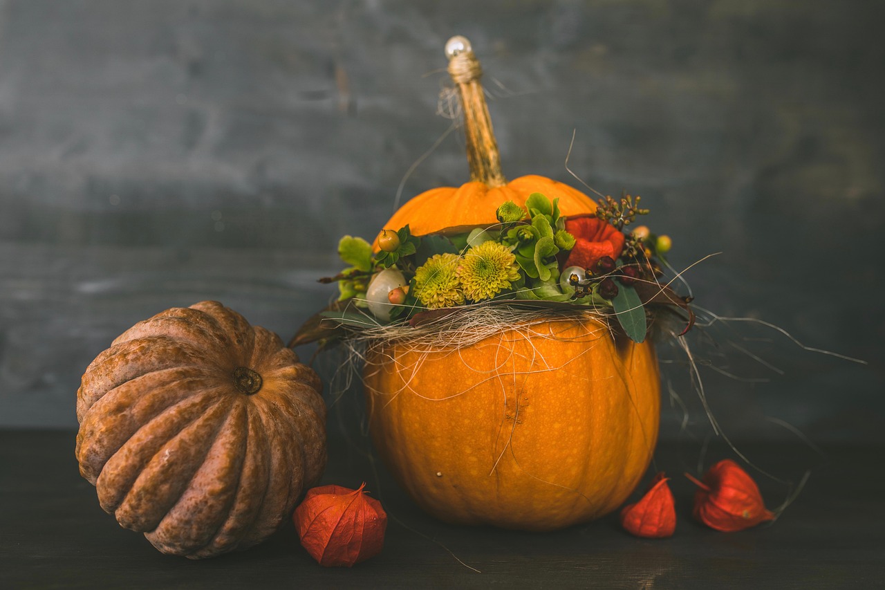 Pumpkins - one being used as the "vase" for a floral arrangement.